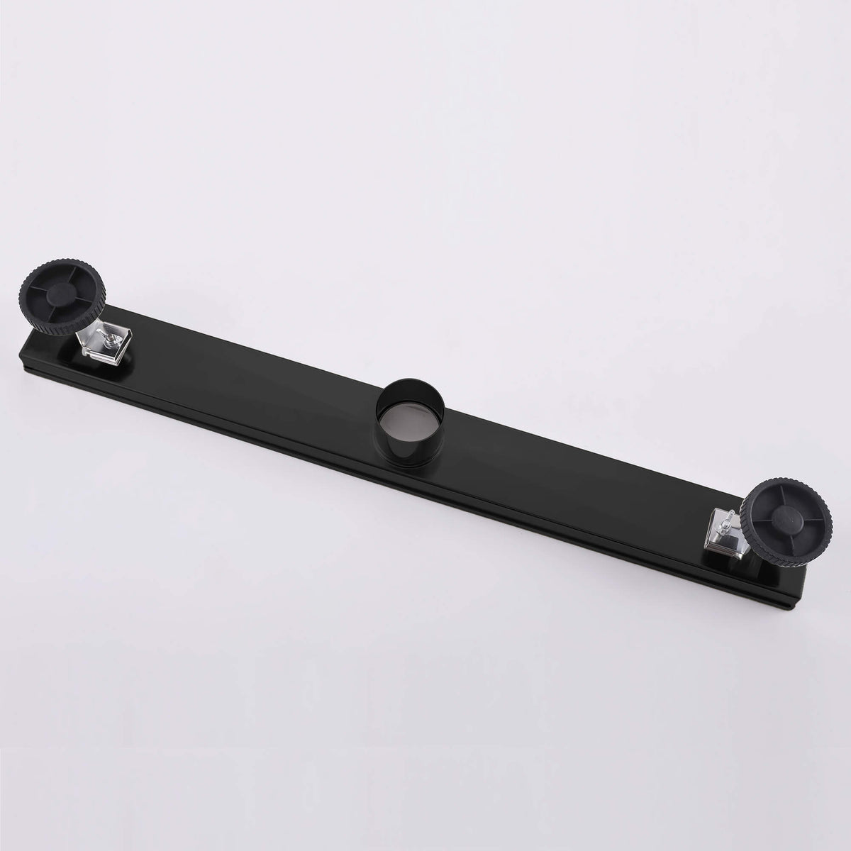 Matte black linear shower drain backside with adjustable leveling feet