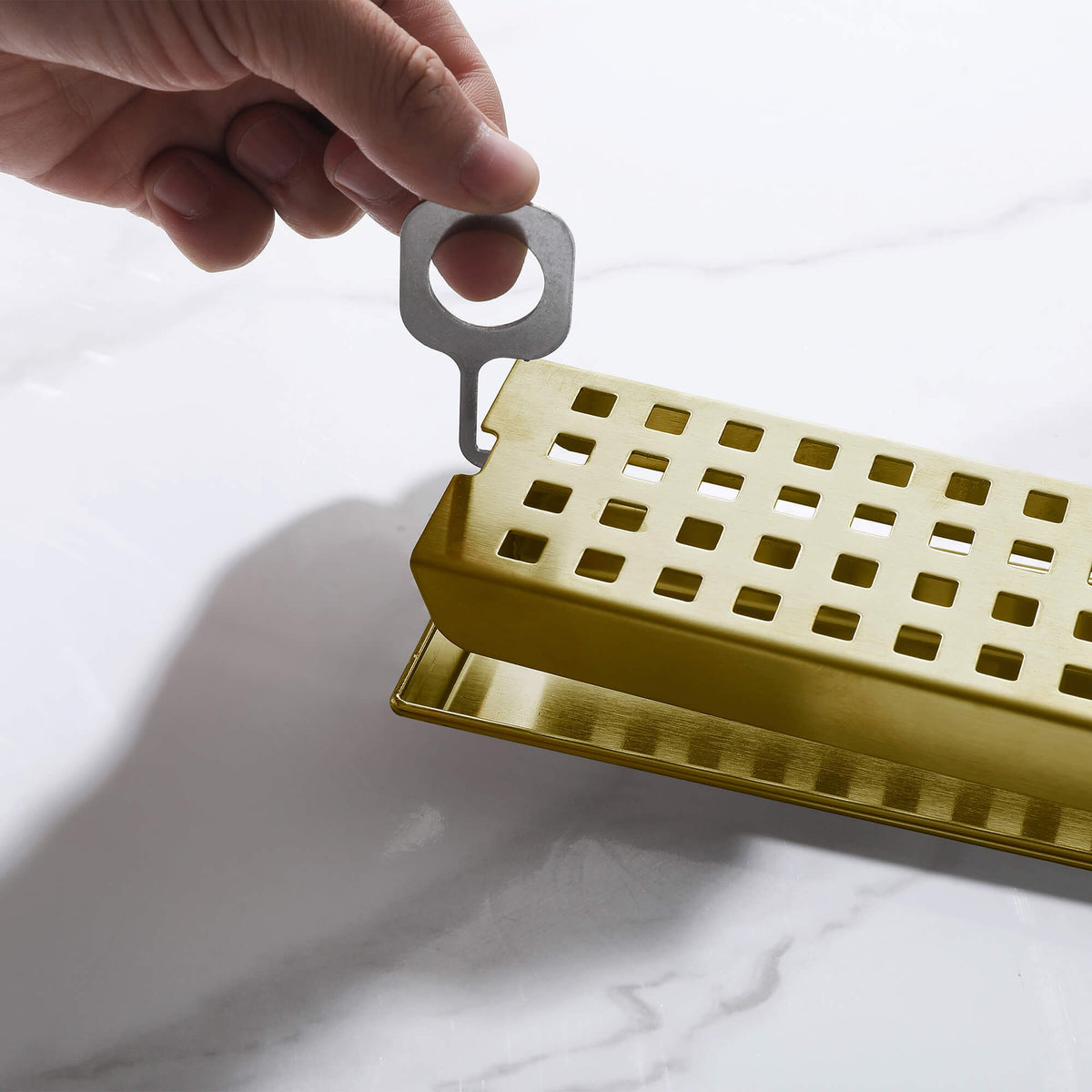 Brushed gold linear shower drain removable grate with lifting key