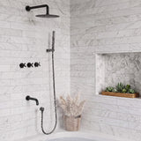 Coordinated black rainfall shower, handheld wand and tub filler operating above a white bathtub with marble-look walls
