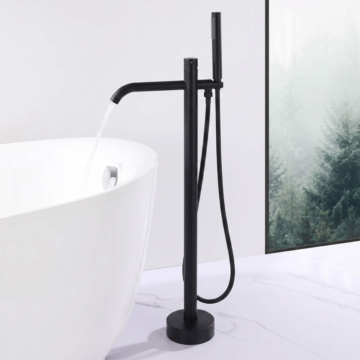 Matte black freestanding tub filler delivering water into a modern bathtub