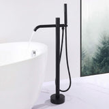 Matte black freestanding tub filler delivering water into a modern bathtub