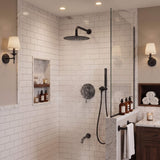 Matte black shower system with rainfall shower head running, handheld shower and wall-mounted tub spout