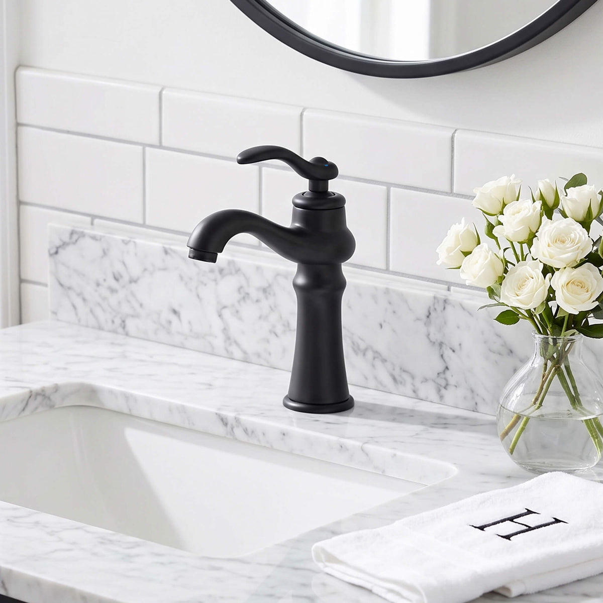 Matte black single handle bathroom faucet installed on a marble vanity countertop