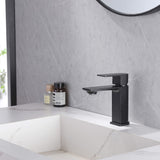 Matte black square single-hole bathroom sink faucet installed on modern vanity
