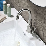 Modern brushed nickel basin faucet installed on white ceramic bathroom sink