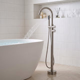Brushed nickel freestanding bathtub faucet with elegant water flow next to modern bathtub