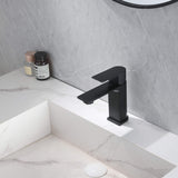 Modern matte black single-handle bathroom faucet installed on white vanity sink