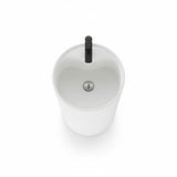 Top view of modern white round pedestal sink with black faucet, minimalist freestanding bathroom basin.