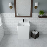 Square freestanding pedestal sink with matte white finish, black faucet, subway tile walls, and wooden mirror frame in a modern bathroom.