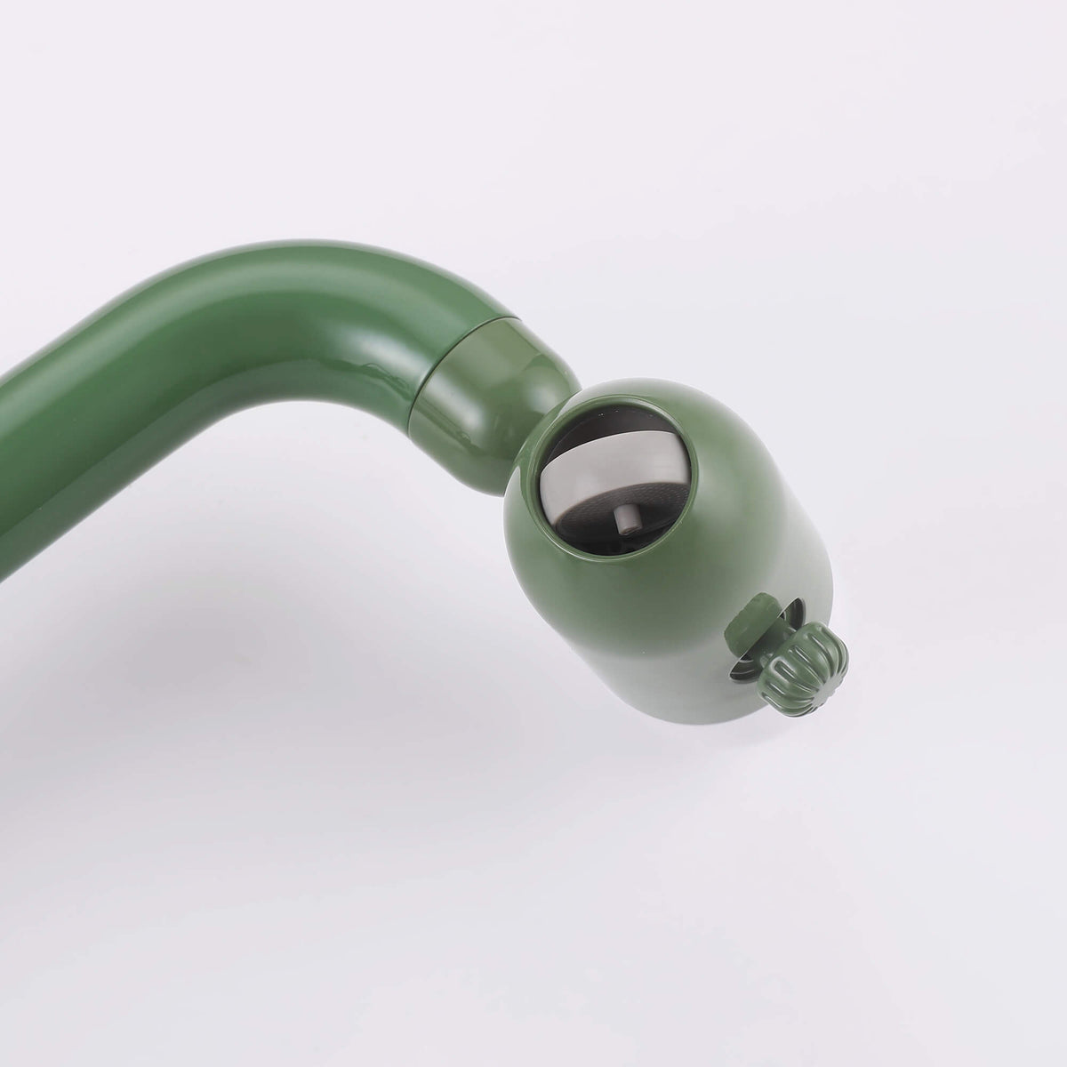 Close-up view of adjustable spray head on olive green bathroom faucet