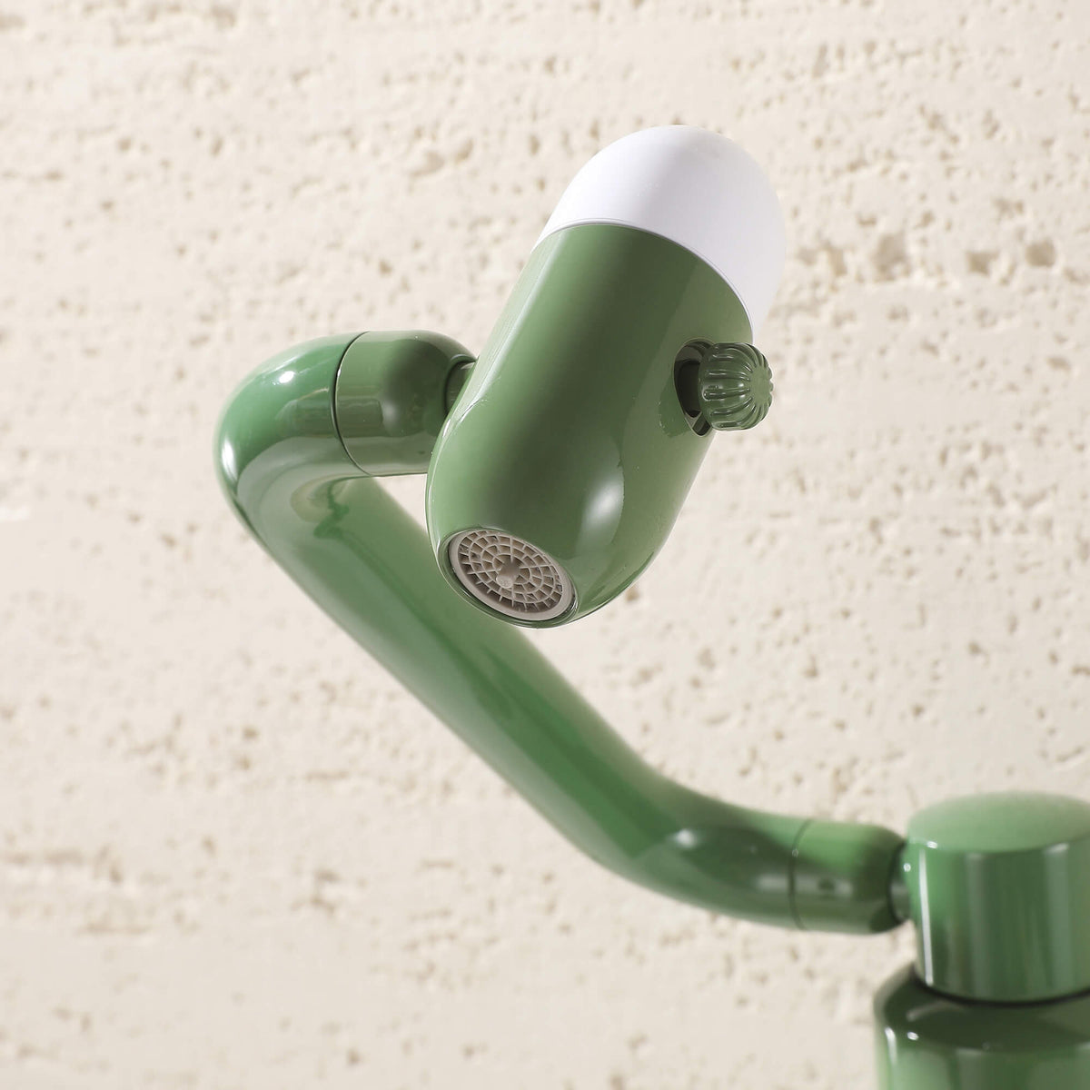 Close-up detail of olive green faucet aerator and spray nozzle