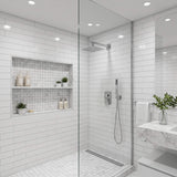 Polished chrome rain shower system installed in modern bathroom with square rainfall shower head and handheld shower