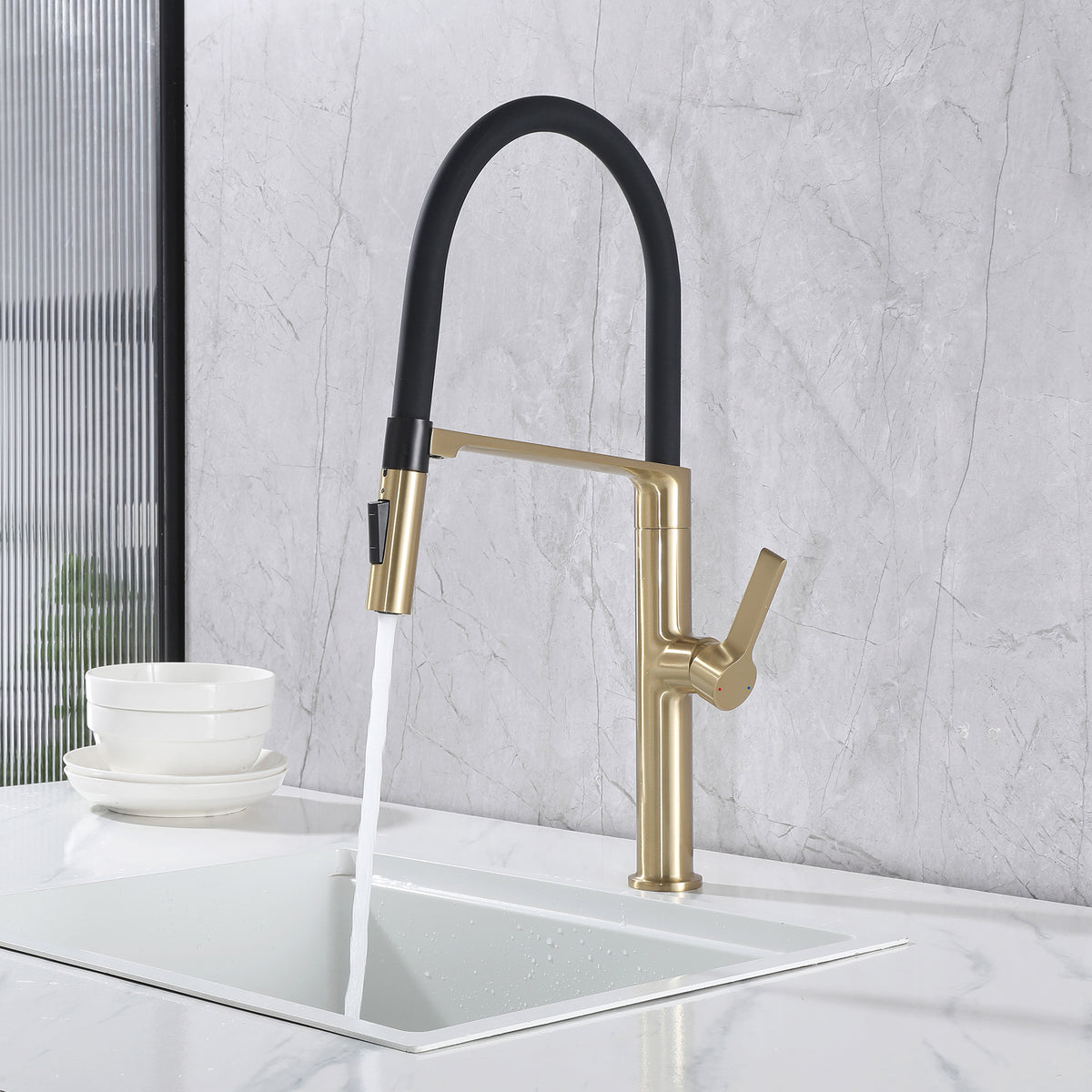 Pull-down kitchen faucet in stream mode over a white kitchen sink