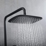 Close-up of square matte black rain shower head with even rainfall water flow