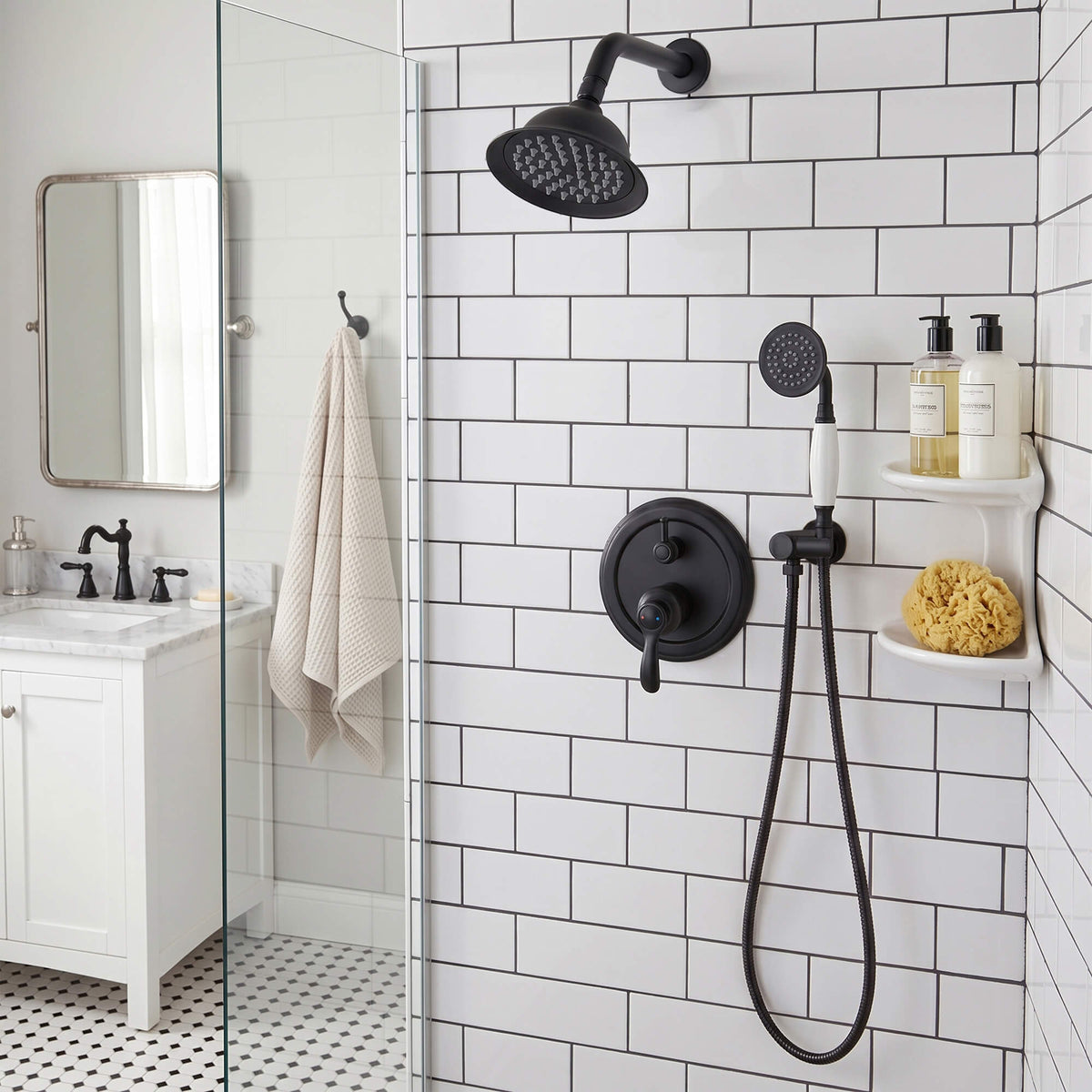 Black shower faucet system with overhead rain shower and handheld shower installed in a white tile bathroom