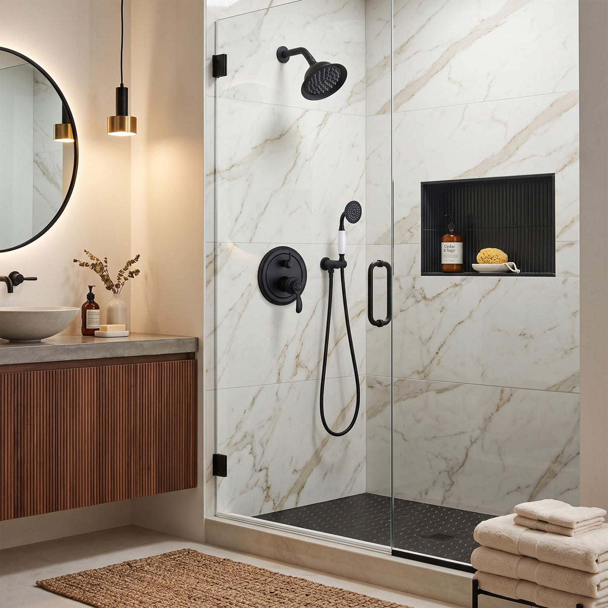 Wall-mounted matte black rain shower system with handheld shower installed in a modern walk-in shower