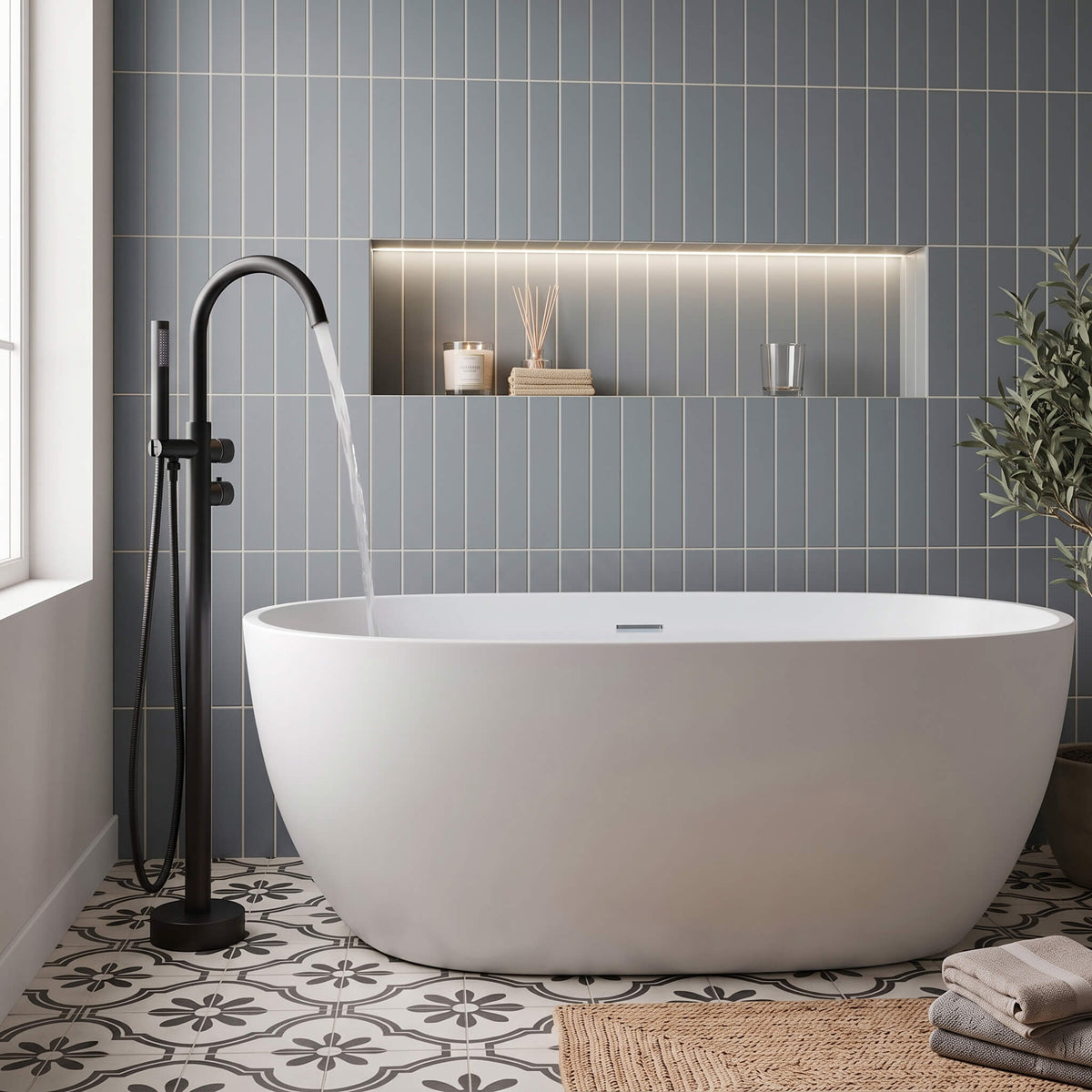 Matte black freestanding bathtub faucet filling a modern white soaking tub