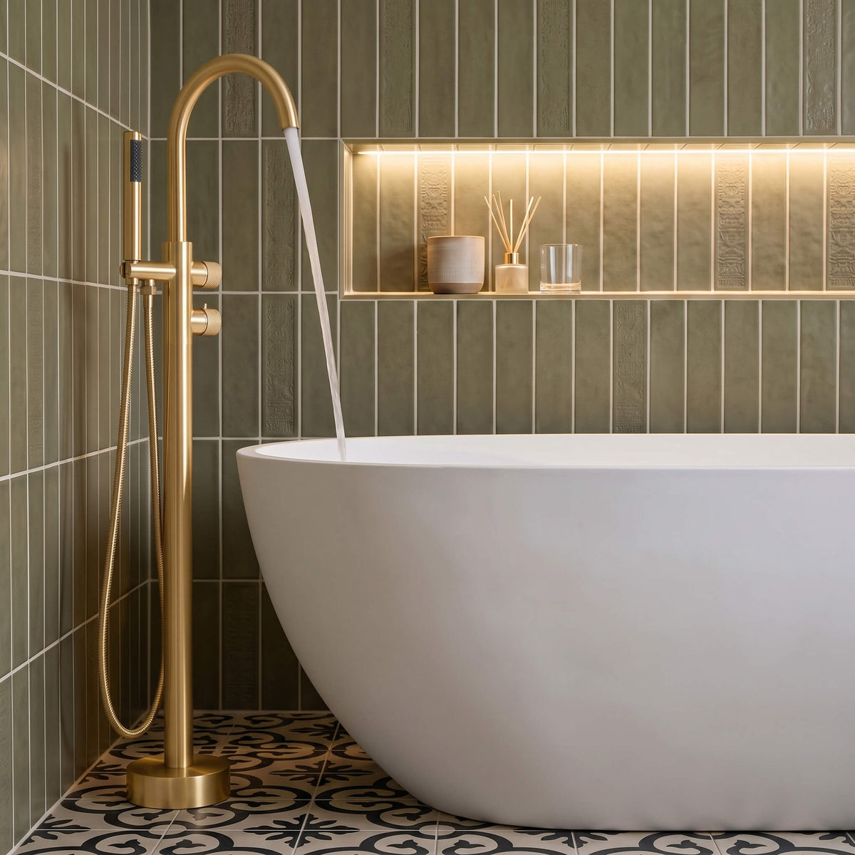 Brushed gold freestanding bathtub faucet filling a modern white soaking tub