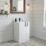 Modern bathroom interior featuring square pedestal sink in matte white resin stone with black faucet, minimalist wall lighting and wood-framed mirror.