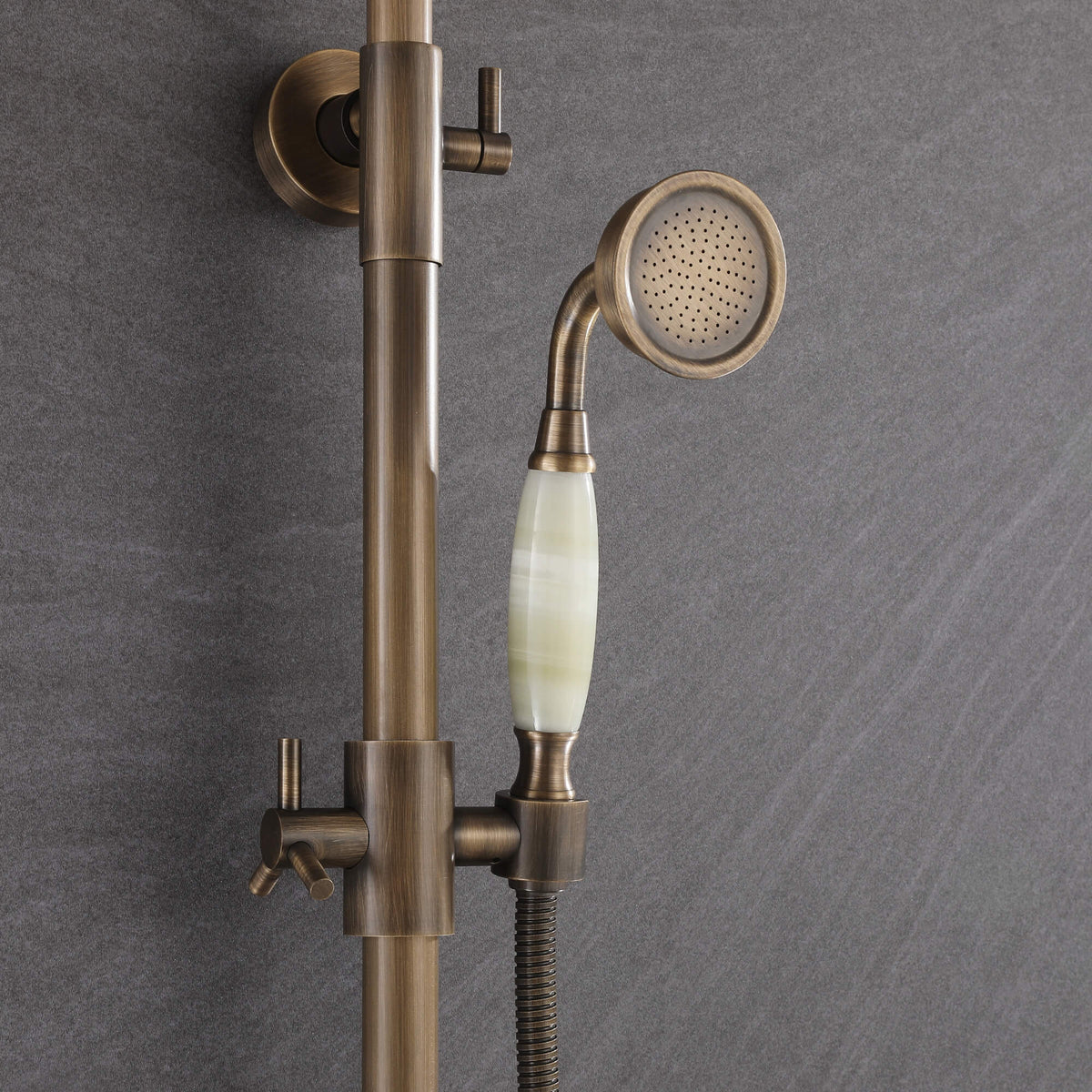 Vintage-style antique brass handheld shower with decorative light-colored handle