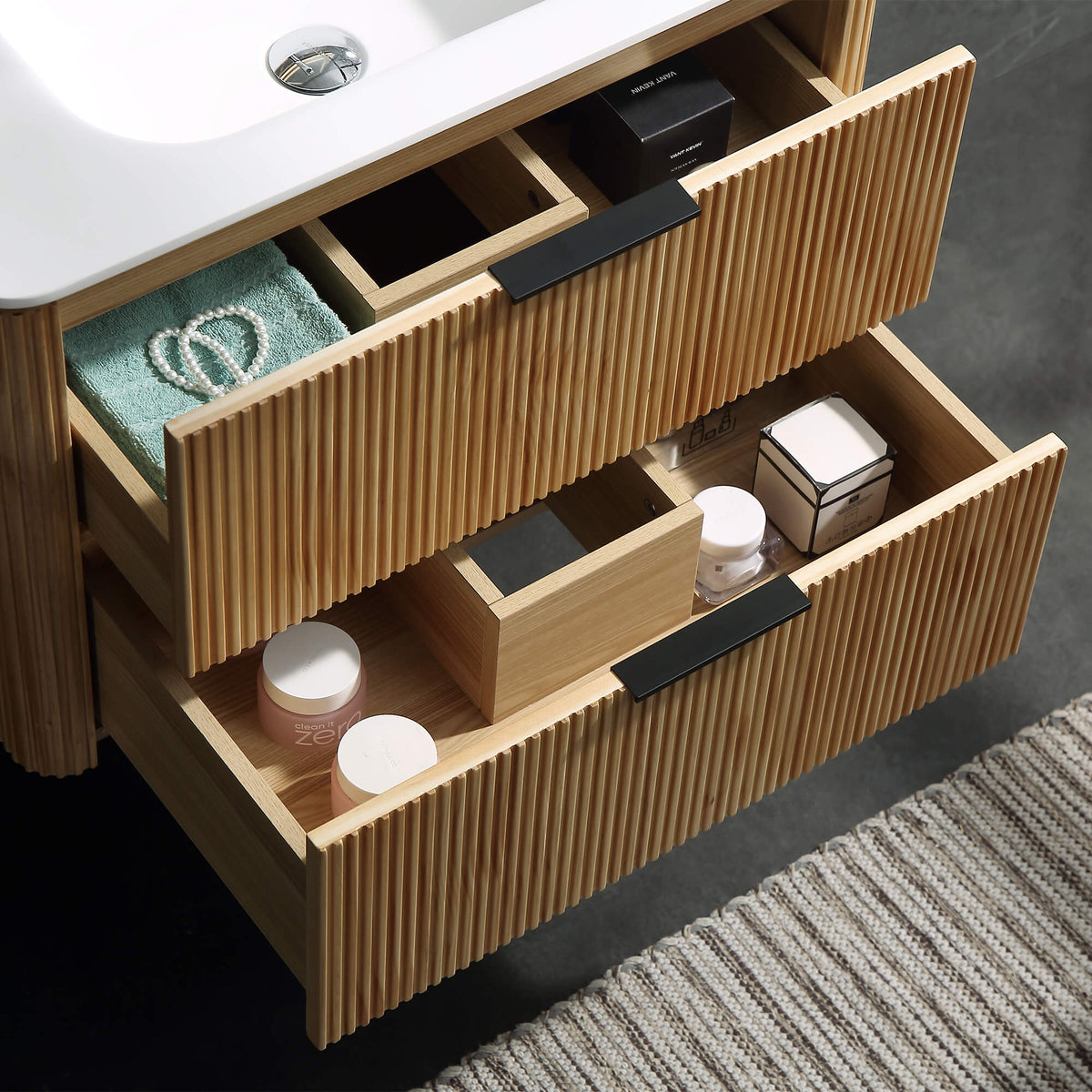 Wall-mounted bathroom vanity with open drawers viewed from above