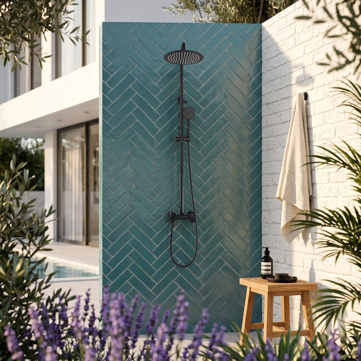 Wall-mounted outdoor shower set installed beside a pool with matte black rain shower and handheld sprayer