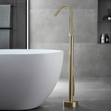 golden freestanding bathtub faucet beside the bathtub